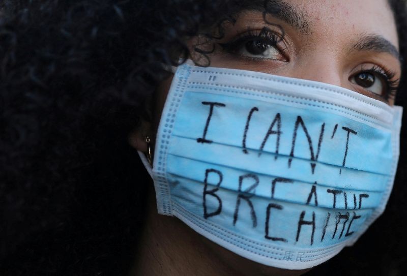 A woman wearing a face mask with the words â€œI can't breathe looks on during a protest against the death in Minneapolis police custody of George Floyd, in front of a U.S. consulate in Barcelona, Spain on June 1, 2020. (Photo by Nacho Doce/Reuters)